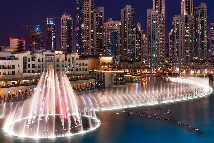 Experience the stunning Dubai Fountain where water dances in harmony with lights set against the backdrop of majestic skyscrapers creating an unforgettable evening spectacle in the heart of the city.